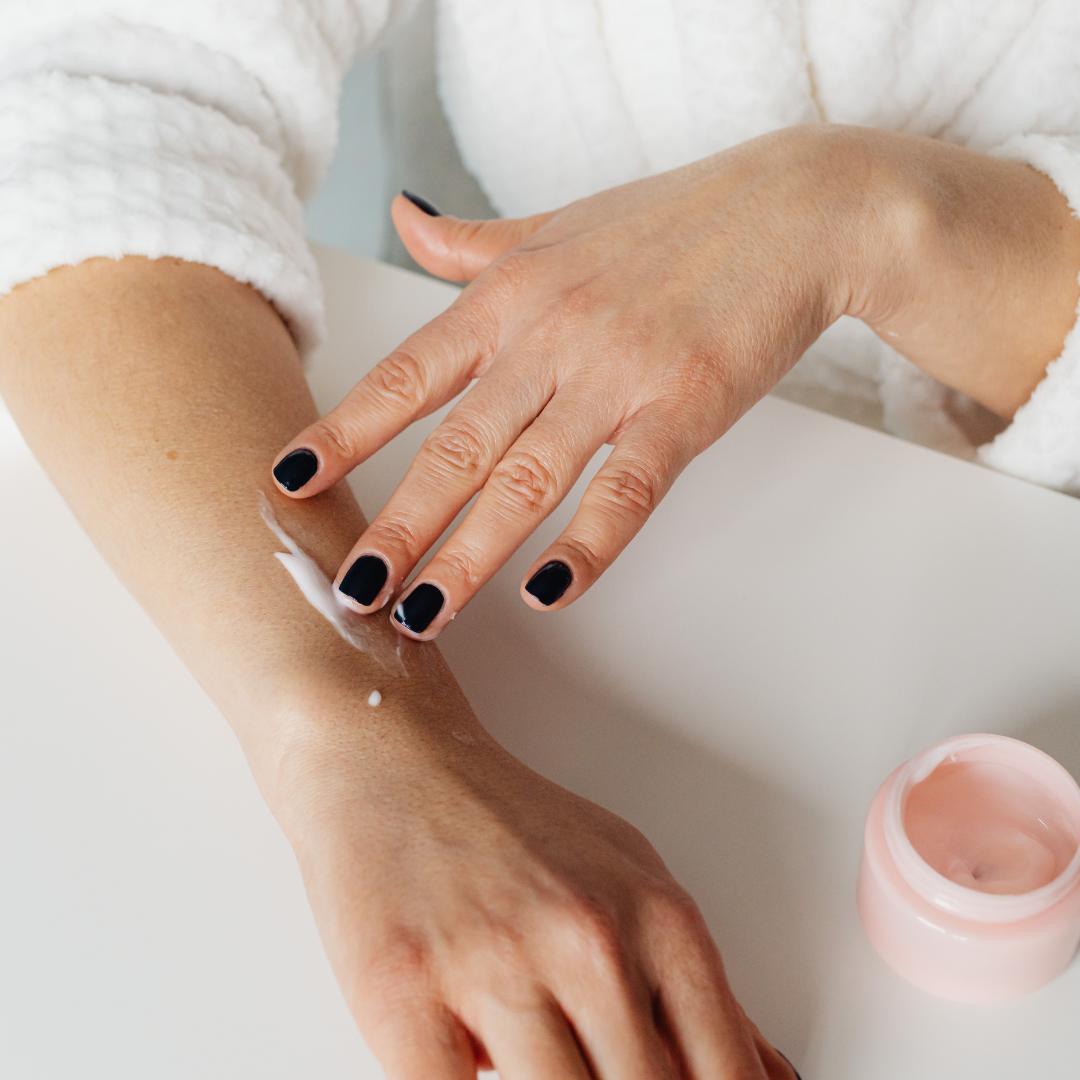 Applying thick moisturizer indoors to prevent eczema flare-ups in cold weather.